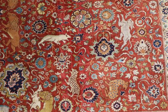 An Indian red and blue ground carpet 319 x 153cm